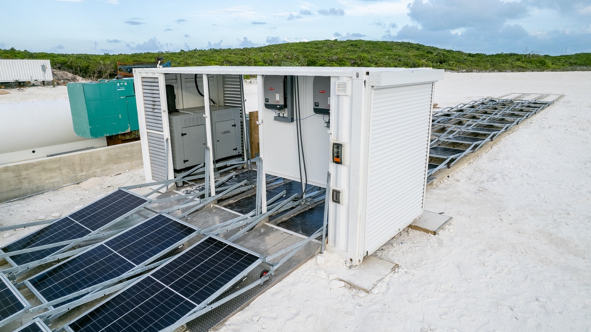 Close up of Solarator® Fold-Out 75+ kVa with solar panel arrays deployed along a stretch of white sand beach