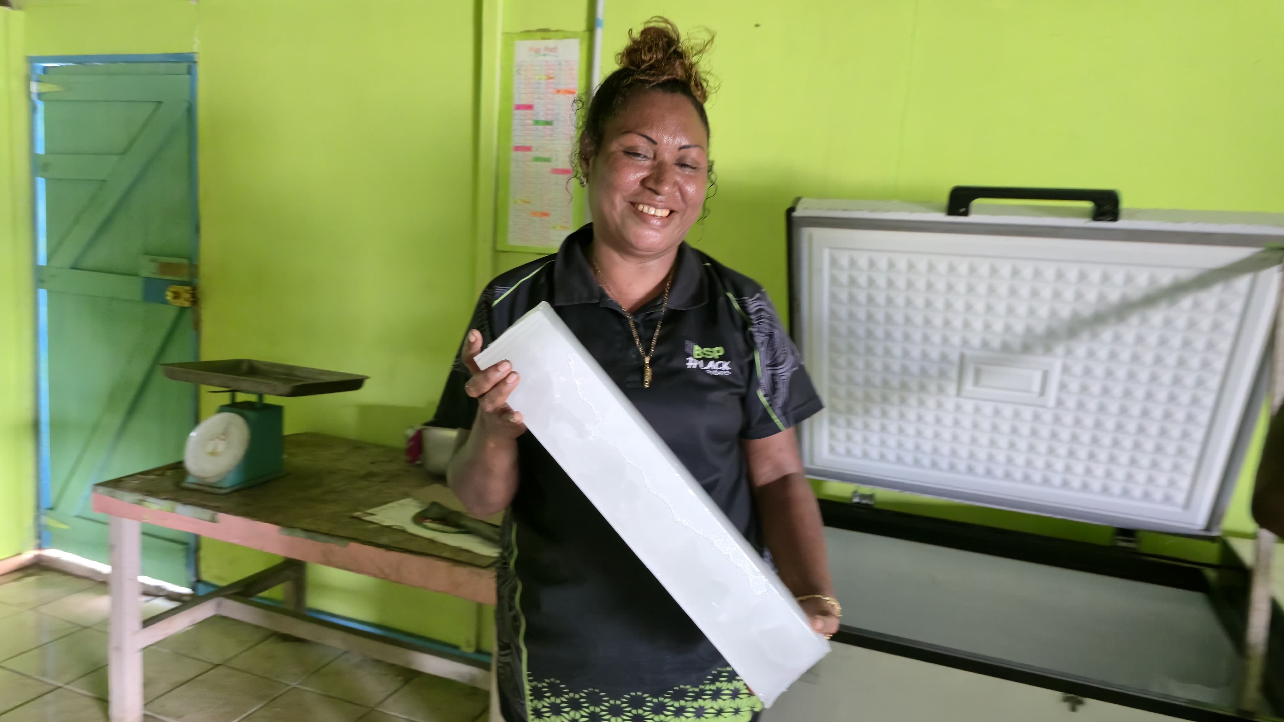 Happy customer showing off ice block harvested from Solarator