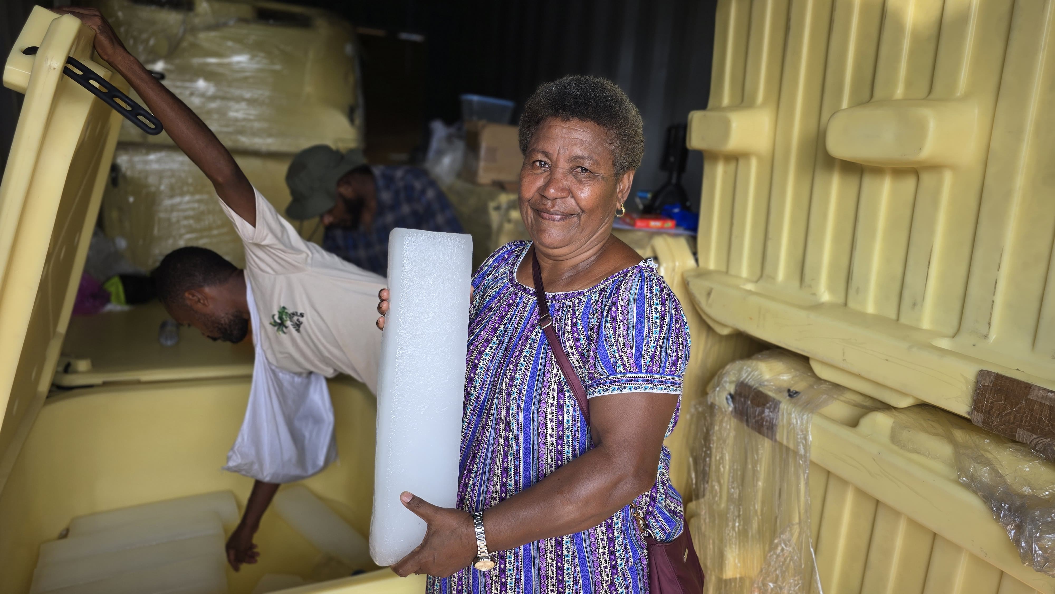 Local entrepreneur showing off ice block harvested from Solarator