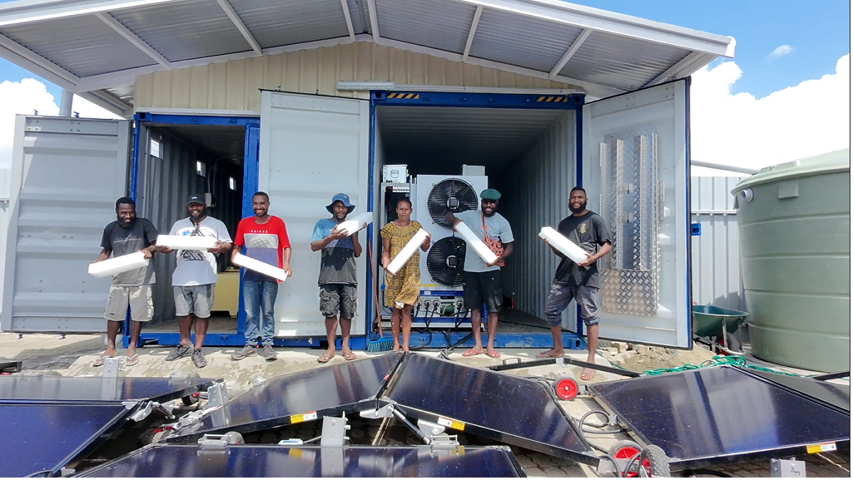 Community members showing ice block harvested from Solarator